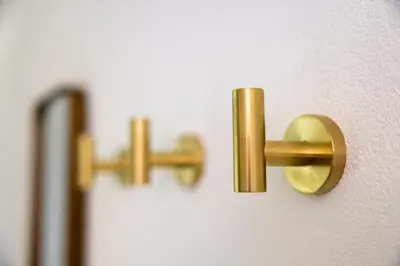 a pair of gold handles on a wall at VISIMO Apartments Steigerstrasse St Gallen - Modern Living near OLMA & Hospital in St. Gallen