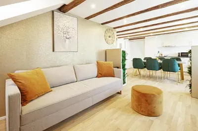 a living room with a couch and a table at VISIMO Apartments Steigerstrasse St Gallen - Modern Living near OLMA & Hospital in St. Gallen