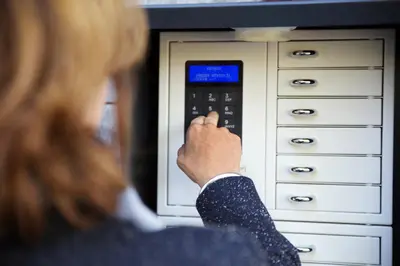 a woman in a suit is adjusting a microwave oven at Hotel Garni Arnegg in Arnegg