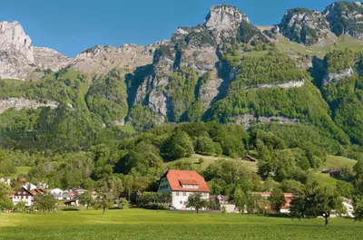 a small village in front of a mountain at Hotel Restaurant Schlössli Sax in Sax