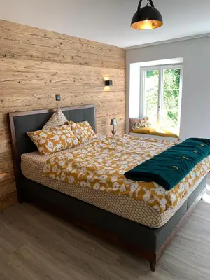 a bedroom with a large bed and a window at Allegra Appenzell in Trogen