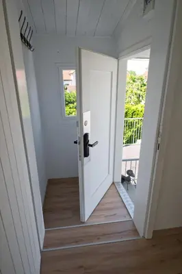 an open white door in a room with a porch at Lake Getaway Apartment with Private entrance, right on the Lake Constance cycle path, barbecue area, free wifi, Netflix and free bikes in Salmsach