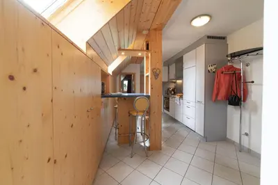 a kitchen with wooden walls and a counter in a room at Vista Montagna in Unterwasser