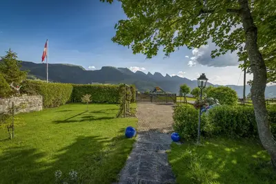 a garden with blue balls on the grass at Capanna in Wildhaus