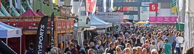 a crowd of people walking down a city street at Appartement Unterstädeli Engelburg SG in Wittenbach