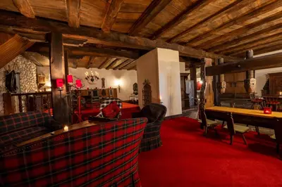 a living room with couches and a red carpet at Schloessli Herrenhof in Herrenhof