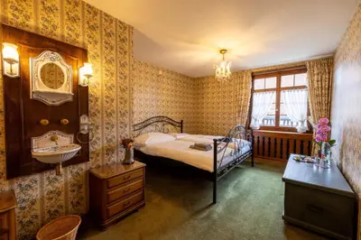 a bedroom with a bed and a sink at Schloessli Herrenhof in Herrenhof