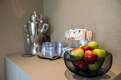 a person cooking food in a pot on a stove at b-smart hotel Arbon in Arbon