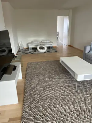 a living room with a couch and a table at Amazing lakeview flat Horn in Horn
