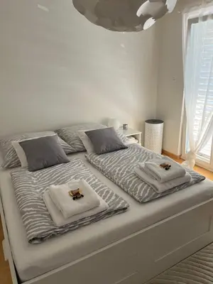 a white bed with towels on top of it at Amazing lakeview flat Horn in Horn