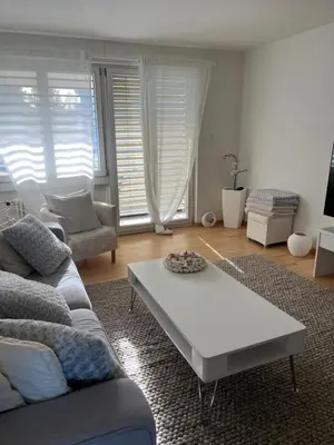 a living room with a couch and a coffee table at Amazing lakeview flat Horn in Horn