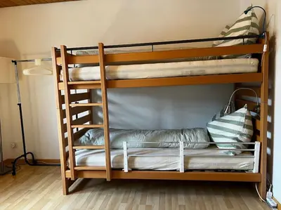 two bunk beds in a room with a lamp at Charmante und zentrale Wohnung am Weiherpark Arbon in Arbon