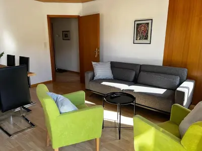 a living room with a couch and two chairs at Charmante und zentrale Wohnung am Weiherpark Arbon in Arbon
