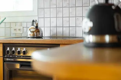 a tea kettle sitting on top of a stove in a kitchen at Luxury apartment with terrace and garden free parking smart TV etc in St. Gallen