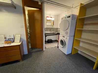 a laundry room with a washer and dryer in it at Blässchopfhüsli in Nesslau