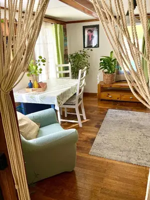 a living room with a table and a couch at Private Room in an old Farmhouse near Vaduz in Sevelen