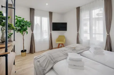 a white room with a bed and a tv at VISIMO Apartments St Georgen-Strasse St Gallen - Design City Nature in St. Gallen
