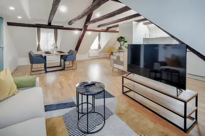 a living room with a large flat screen tv at VISIMO Apartments St Georgen-Strasse St Gallen - Design City Nature in St. Gallen