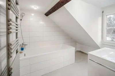 a white bathroom with a tub and a sink at VISIMO Apartments St Georgen-Strasse St Gallen - Design City Nature in St. Gallen