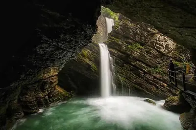 a waterfall in a rocky canyon with green water at Beautiful holiday apartment in Wildhaus Toggenburg in Wildhaus