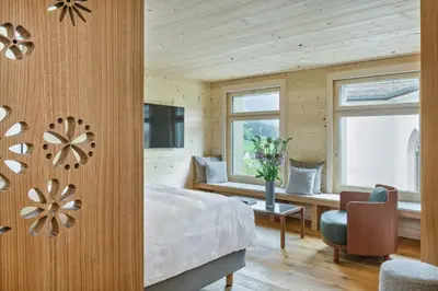 a bedroom with a bed and a window and a television at Appenzeller Huus Löwen in Gonten