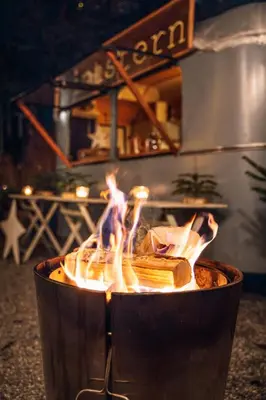 a fire in a pot with flames in it at Fischerhäuser Romanshorn in Romanshorn