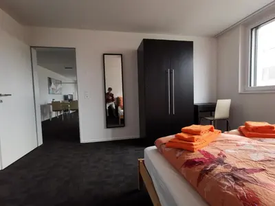 a bedroom with a bed with orange towels on it at Ferienwohnung Hirschen in Gossau