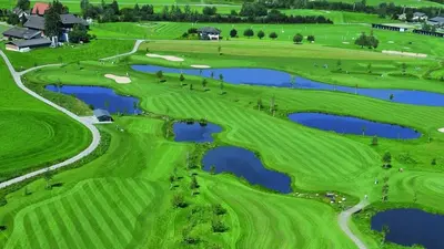 an aerial view of a golf course with two ponds at Ferienwohnung Hirschen in Gossau