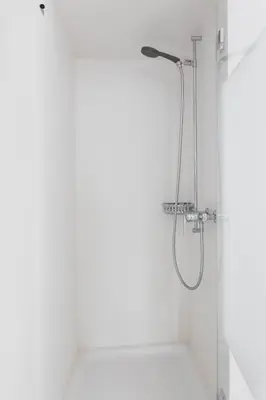 a shower with a glass door in a bathroom at Landgasthof Adler in 9304 Bernhardzell in Häggenschwil
