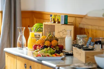 a counter with a bunch of fruit in a basket at Hotel Restaurant Berghaus Malbun Buchserberg in Buchs