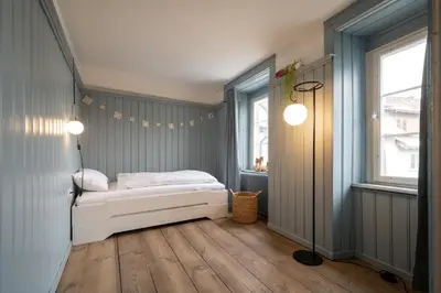 a small bedroom with a bed and a window at JACOB 1808. fine historic town apartments in Bischofszell