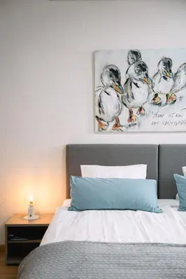 a bedroom with a bed with a picture of ducks at Hotel & Restaurant Nollen in Hosenruck