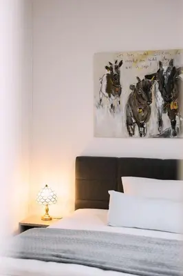 a bedroom with a bed with a painting on the wall at Hotel & Restaurant Nollen in Hosenruck