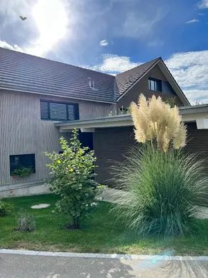 a house with a fence and plants in front of it at Ferienhausträume Oase Bodensee in Kreuzlingen