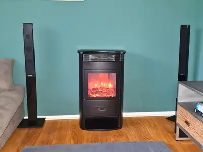 a stove with a fire in a living room at Ferienhausträume Oase Bodensee in Kreuzlingen